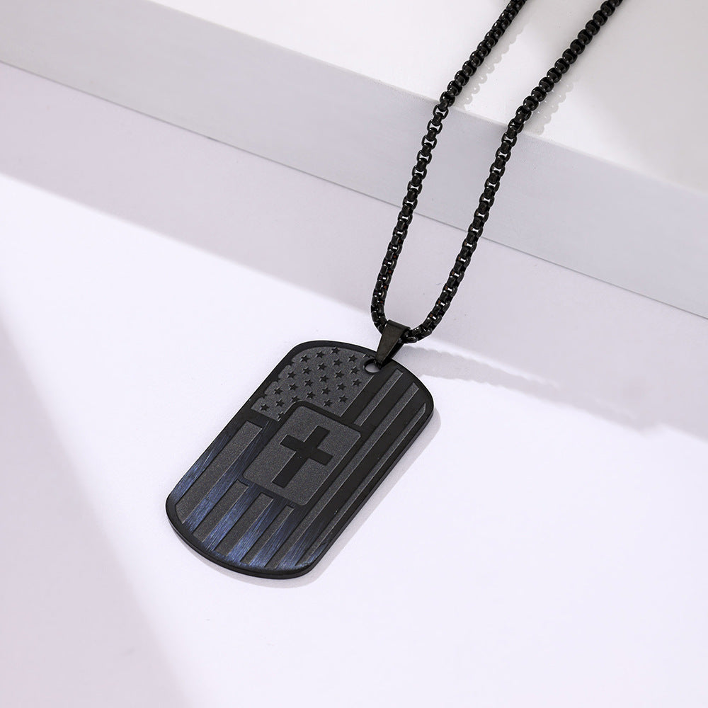 Black dog tag necklace with a cross design on a white background