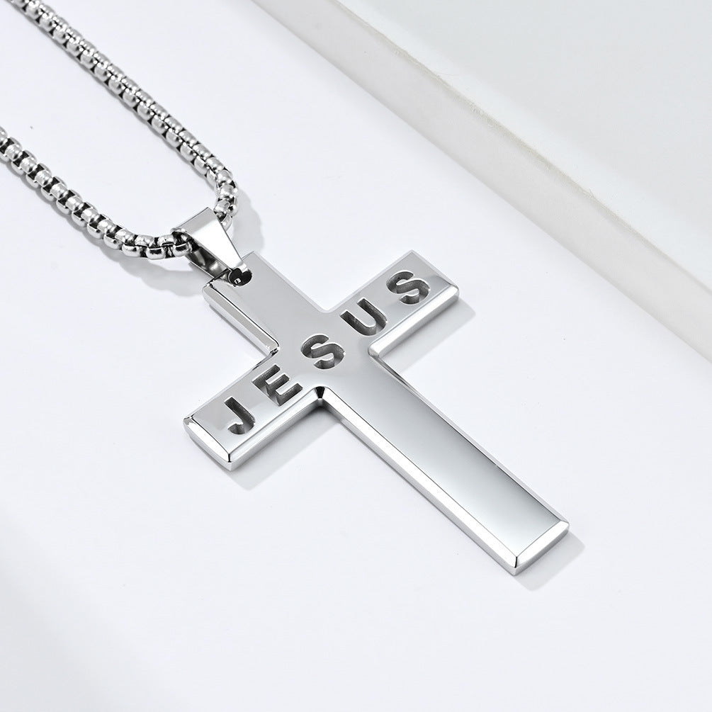 Silver cross pendant with 'JESUS' engraved on a white background