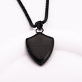Black shield-shaped pendant on a white background