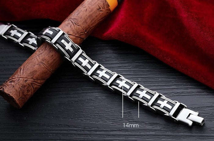 Silver bracelet with black accents on a dark surface with a red fabric background