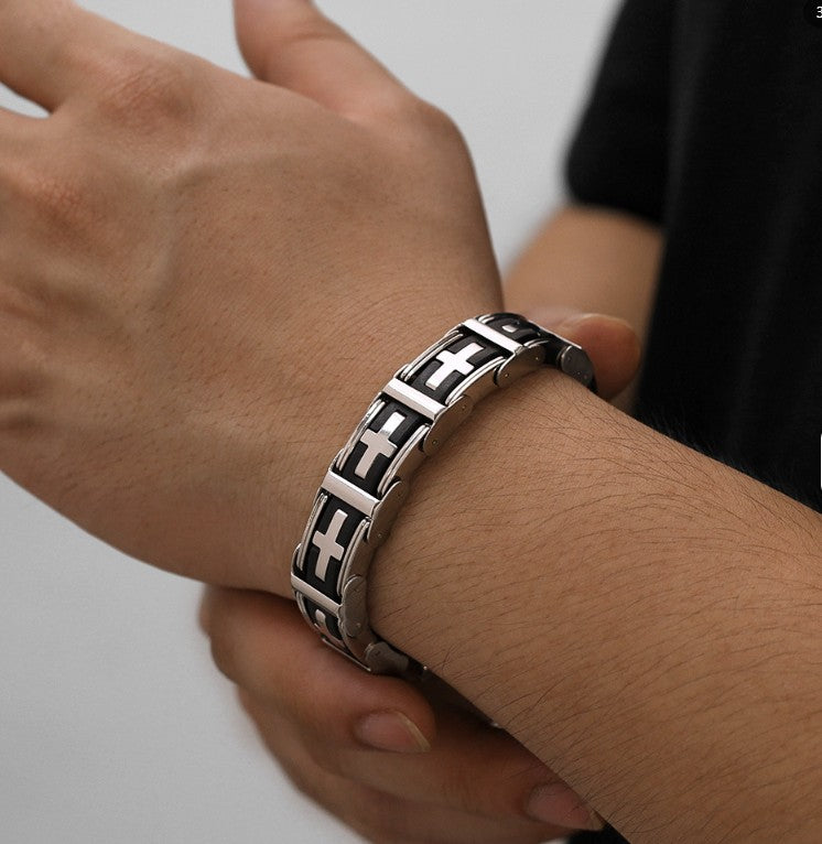Silver bracelet with geometric design on a wrist against a neutral background