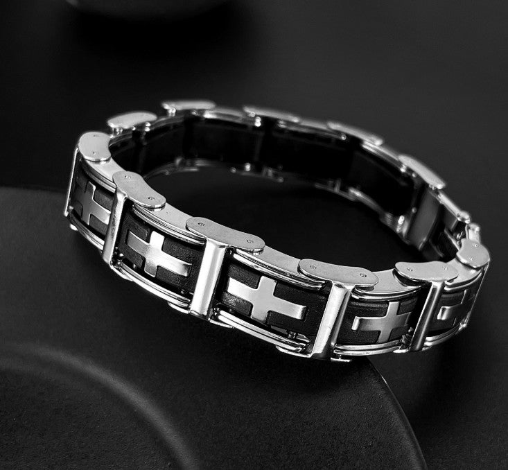 Metallic bracelet with cross designs on a dark background