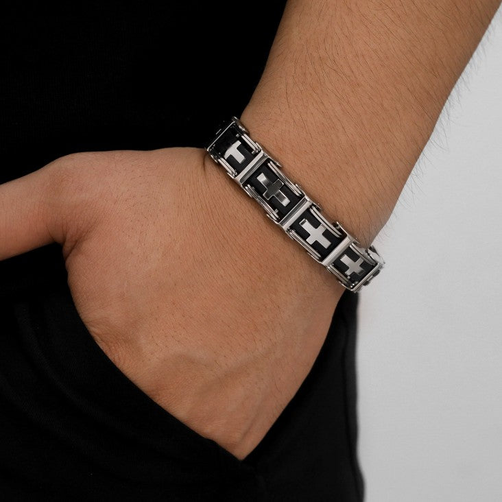 Silver bracelet with geometric design on a wrist against a neutral background