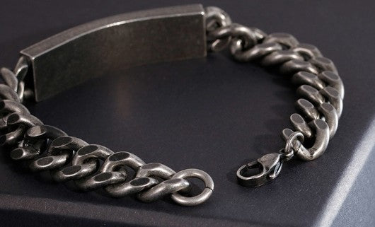 Silver chain bracelet on a dark background