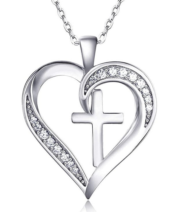 Silver heart-shaped pendant with a cross and clear stones on a white background