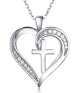 Silver heart-shaped pendant with a cross and clear stones on a white background