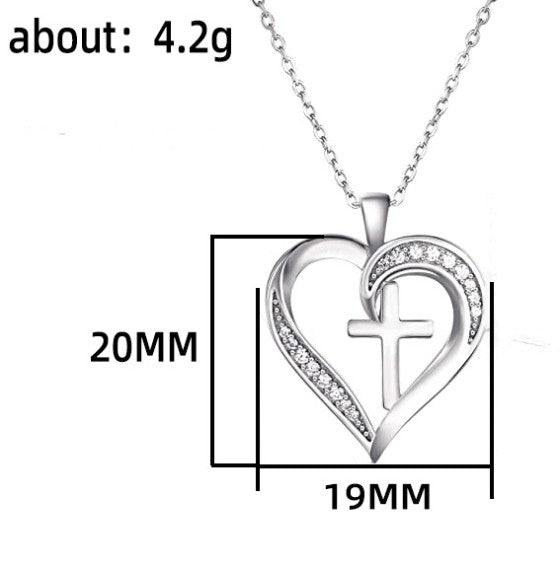 Silver heart-shaped pendant with cross design on a white background