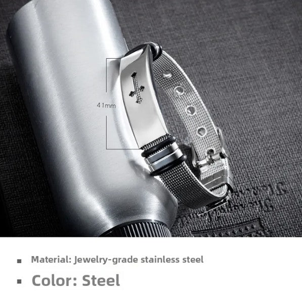 Close-up of a steel bracelet with detailed design on a textured surface