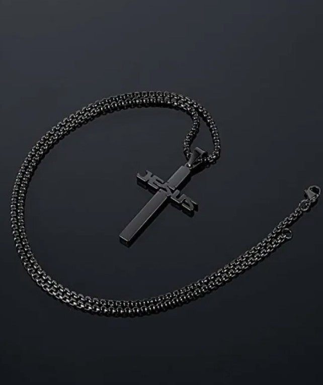 Black chain necklace with a cross pendant on a dark background