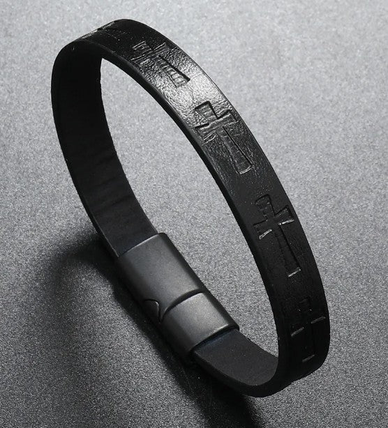 Black leather bracelet with metallic clasp on a gray background