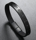 Black leather bracelet with metallic clasp on a gray background