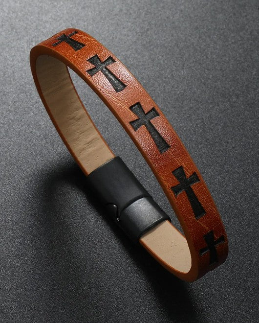 Brown leather bracelet with black cross patterns on a gray background