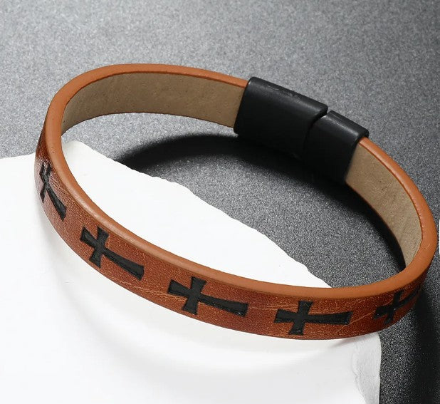 Brown leather bracelet with black cross patterns on a gray background