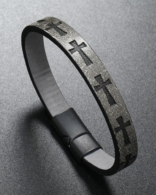 Gray leather bracelet with cross patterns on a gray background
