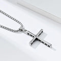 Silver cross necklace on a white background