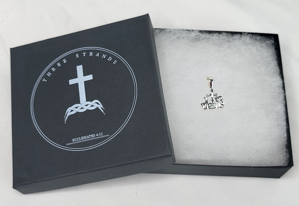 Silver cross pendant in a black jewelry box with 'Three Strands' branding.