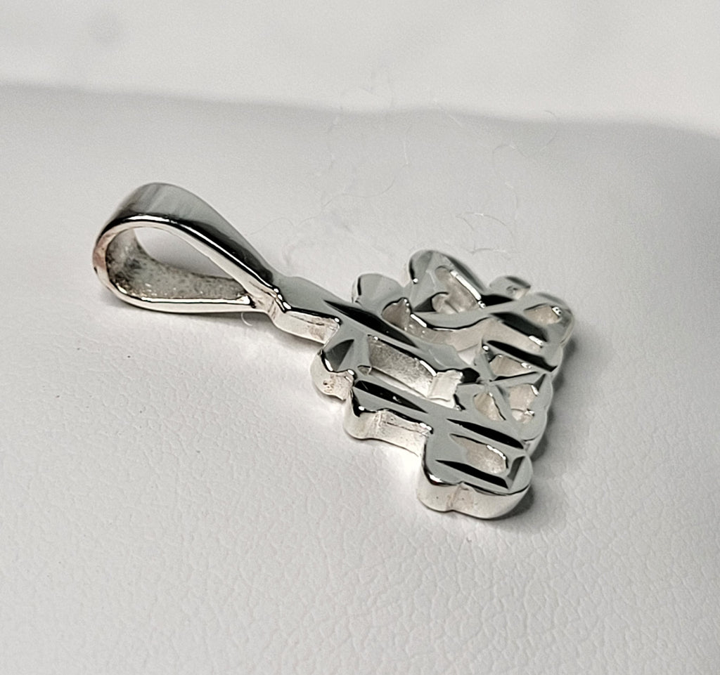 Silver I Love Jesus pendant, side view, on a light gray background