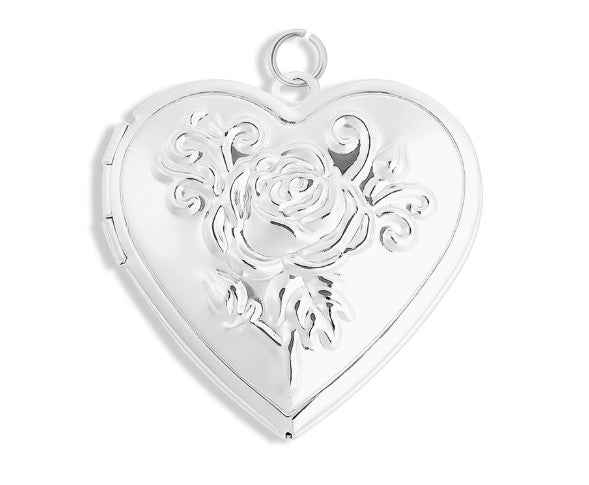 Silver heart-shaped locket with floral design on a white background