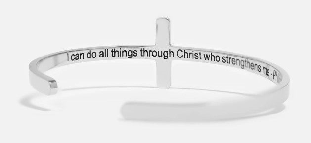 Silver bracelet with motivational quote and cross design on a white background