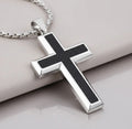 Silver cross pendant with black carbon fiber inlay on a light gray background