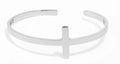Silver bracelet with a cross design on a white background