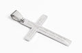 Silver cross pendant with engraved text on a white background