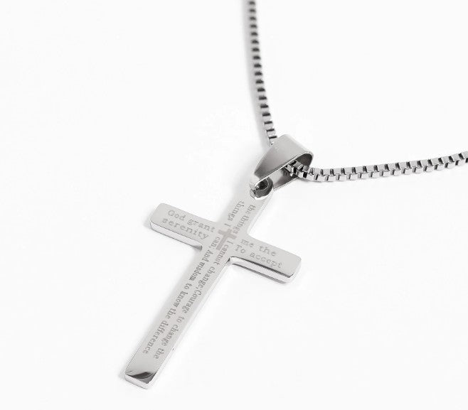 Silver cross pendant necklace on a white background
