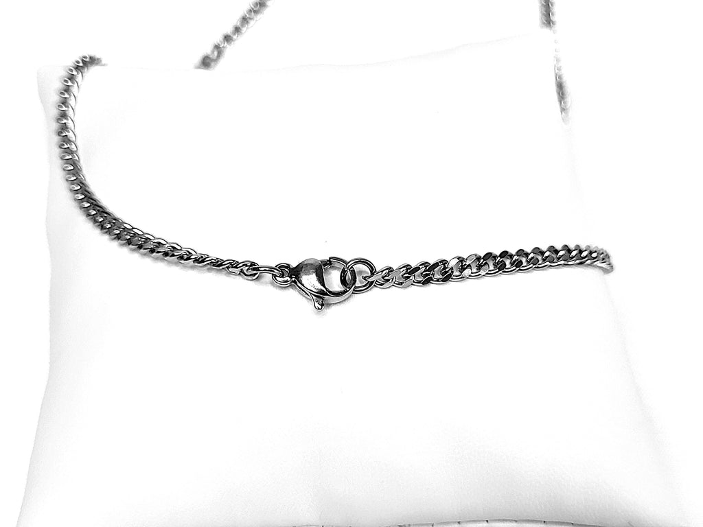 Silver chain belt on a white cushion