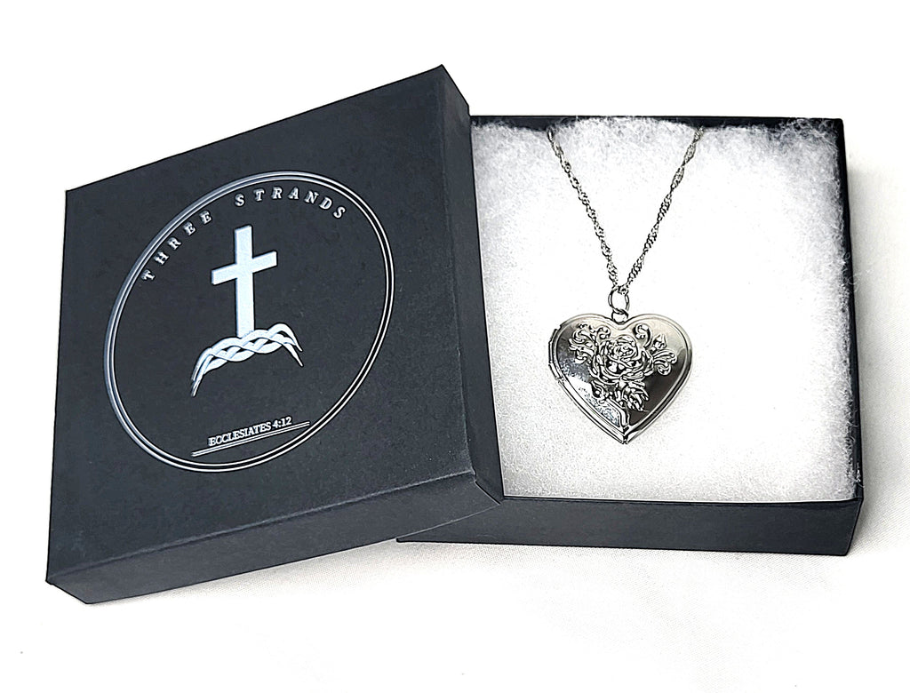 Heart-shaped silver pendant necklace in a branded Three Strands box