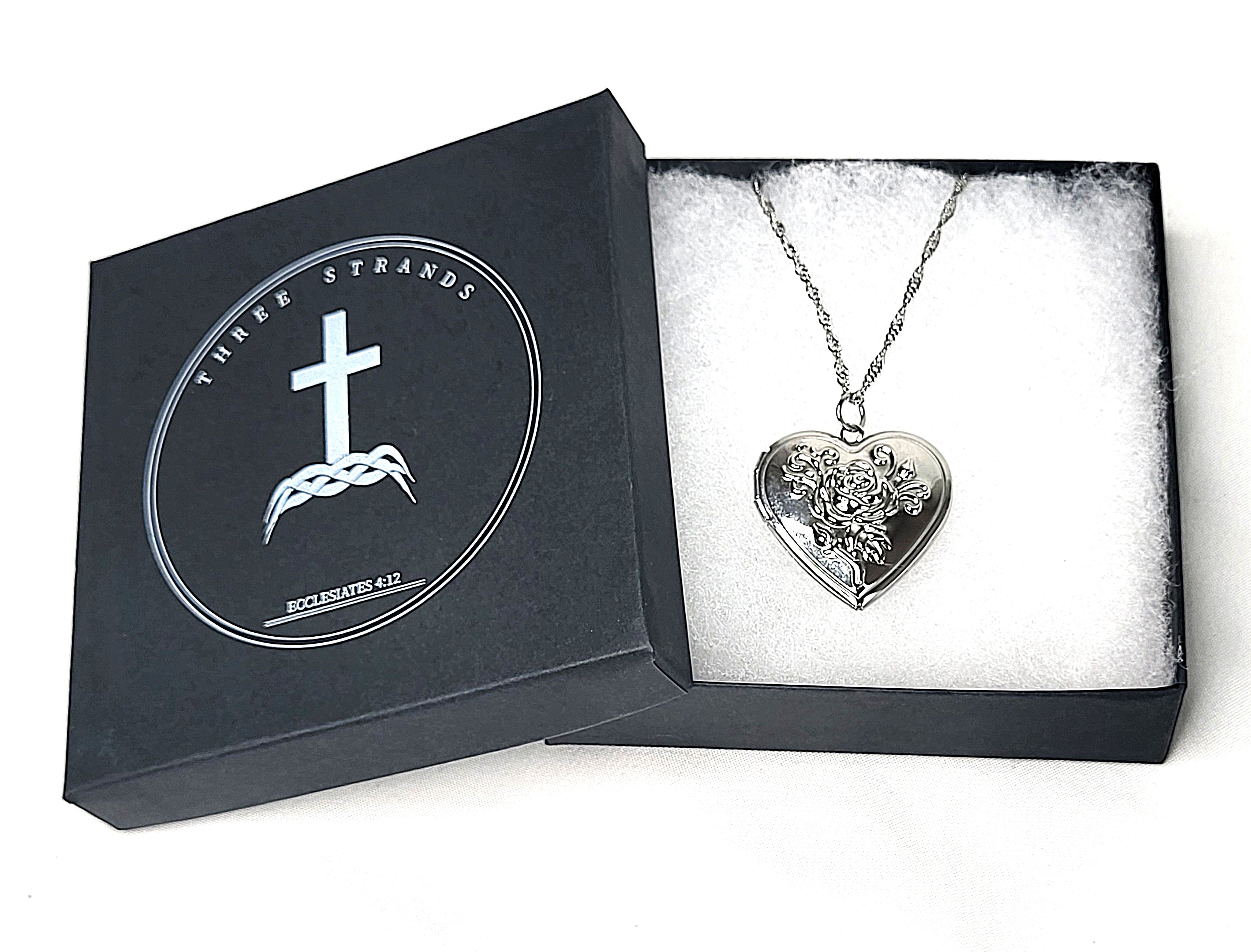 Heart-shaped silver pendant necklace in a branded Three Strands box